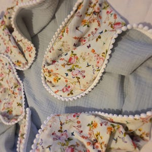 A Soft Idea Cotton Muslin Swaddle Blanket with Pom Poms