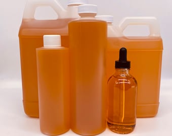 May include: Four bottles of amber-colored liquid, ranging in size from a small bottle with a dropper to a large gallon jug. The bottles are all made of clear glass or plastic and have white caps.