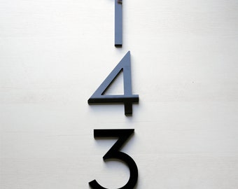 May include: Black house numbers 143 on a white background.