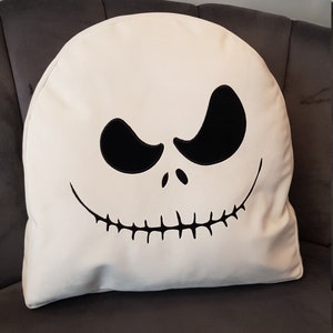 May include: White pillow with a black embroidered Jack Skellington face from the Nightmare Before Christmas movie.