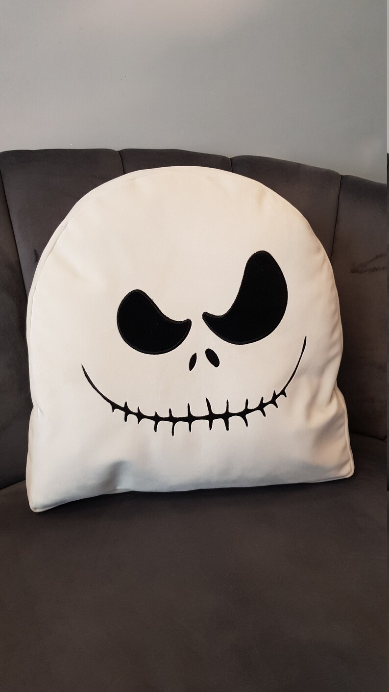 May include: White pillow with a black embroidered Jack Skellington face from the Nightmare Before Christmas movie.