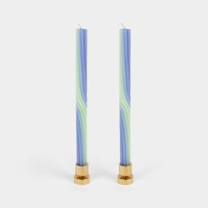 May include: Two blue and green striped candles with gold bases.