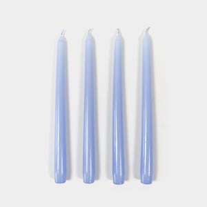 May include: Four light blue taper candles. The candles are approximately 7 inches long.