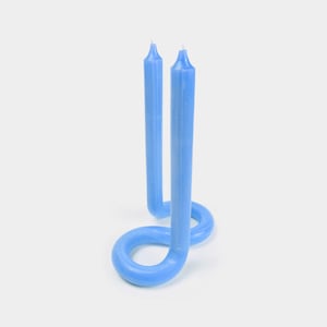 May include: Two blue spiral candles, one on top of the other, forming a circle.