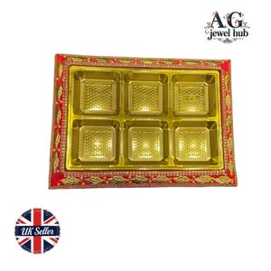 May include: A gold-coloured sweet box with six square compartments. The box is trimmed with red fabric and gold embellishments. The image also includes the text "AG jewel hub" and a "UK Seller" sticker.