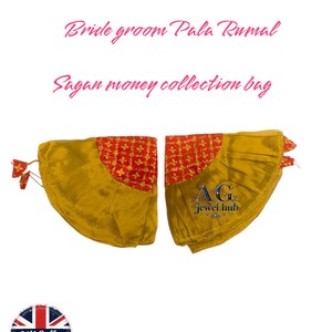 Puede incluir: Dos piezas de tela dorada con detalles rojos estampados, posiblemente para una ceremonia. Se lee "Bride groom Pala Rumal" y "Sagan money collection bag". Con borlas y el logo "AG jewel hub".