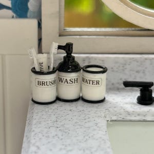 Dollhouse 1/12 scale miniature bathroom set with toothbrushes and toothpaste. Includes a glass for water, toothbrushes and soap dispenser