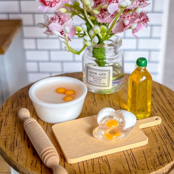 Dollhouse 1/12 scale miniature set of cutting board, bowl with eggs, cracked egg, bottle of oil and rolling pin