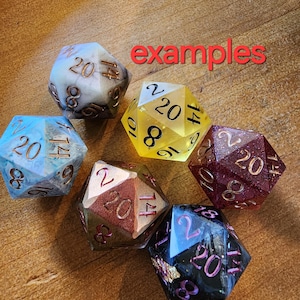 May include: Six multi-colored 20-sided dice with gold and silver accents. The dice are made of resin and have a variety of colors and patterns.