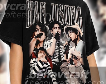 May include: Black t-shirt featuring a graphic print of a band called "HAN JISUNG". The band members are wearing striped shirts and holding microphones.