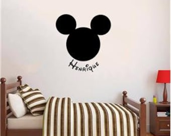 May include: Black and white Mickey Mouse head silhouette wall decal with the name Henrique written underneath.