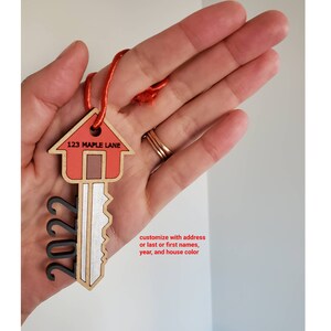 New home ornament with either address, last name or first names. Customize year and house color