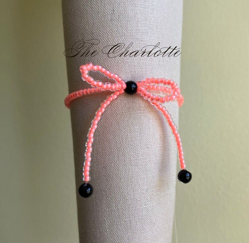 Coral orange bead stretch bracelet with black beading