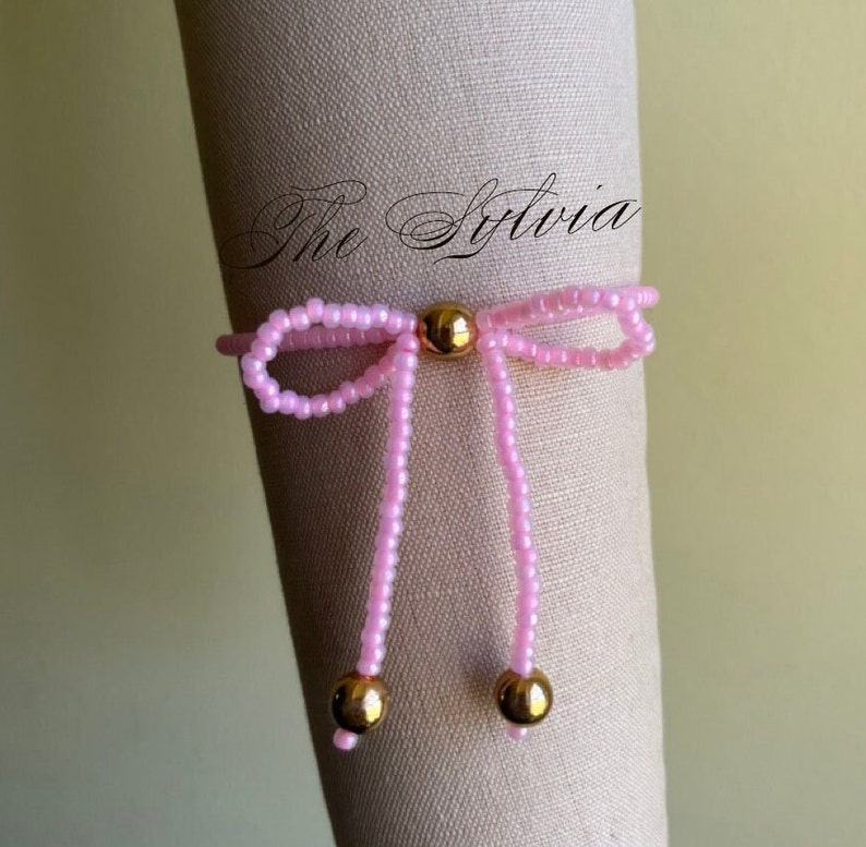 Ballet pink bead stretch bracelet with gold tone beading