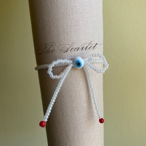 White Bead stretch bracelet with an evil eye