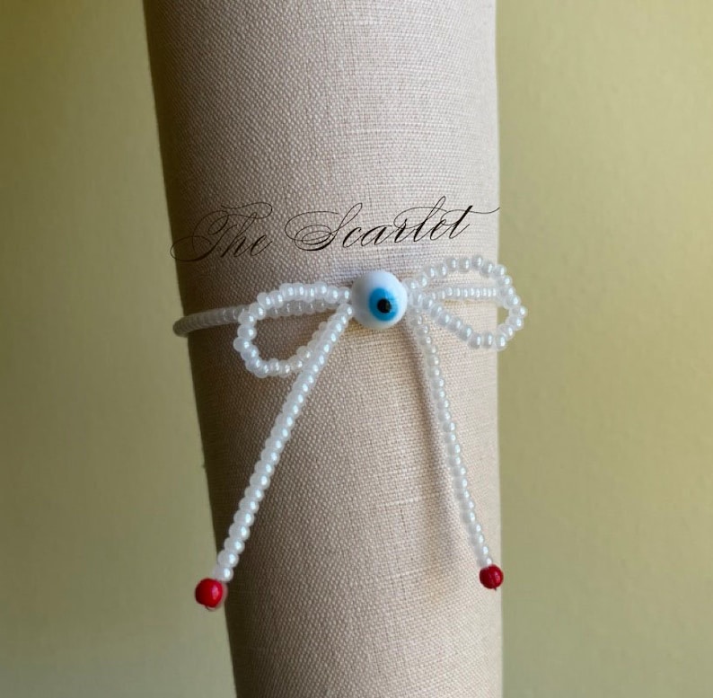 White Bead stretch bracelet with an evil eye