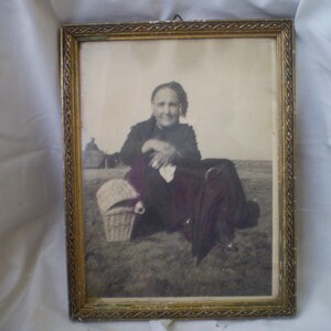 vintage framed photo of an adult woman and a man with a cart black and white photography