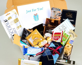 May include: A gift box filled with various items, including a black and white patterned sock, a chocolate bar, a small box of Oreos, a small box of tea bags, a small bottle of face cream, and a small bottle of hand cream. The box is decorated with a blue and white ribbon and the words "Just For You!" and "Congratulations!" are printed on the box.