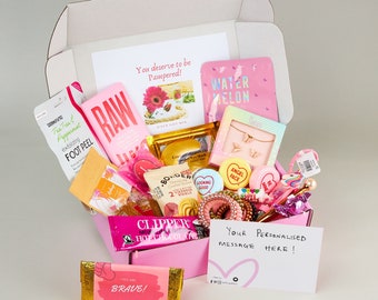 May include: Pink and white gift box filled with various self-care items, including face masks, foot peel, bath bombs, and a chocolate bar. The box also includes a handwritten note that says "Your Personalised Message Here!"