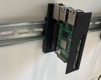 May include: A black 3D printed case for a Raspberry Pi computer, mounted on a metal rack. The case has cutouts for the Raspberry Pi's ports, including USB, HDMI, and Ethernet.