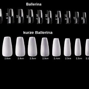 May include: A set of ten white ballerina-shaped false nails in various sizes. The nails are arranged in two rows, with the larger nails in the top row and the smaller nails in the bottom row. The nails are labeled with their size in centimeters.