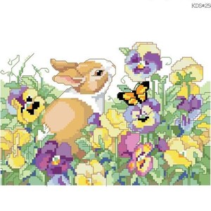 May include: A cross-stitch pattern chart titled "Pansy Patch Bunny" by Nancy Rossi. The design features a bunny amidst colorful pansies and a butterfly. The chart is from Kooler Design Studio.