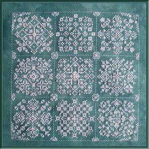 May include: A green fabric with nine white snowflake designs embroidered on it. The snowflakes are arranged in a grid pattern.