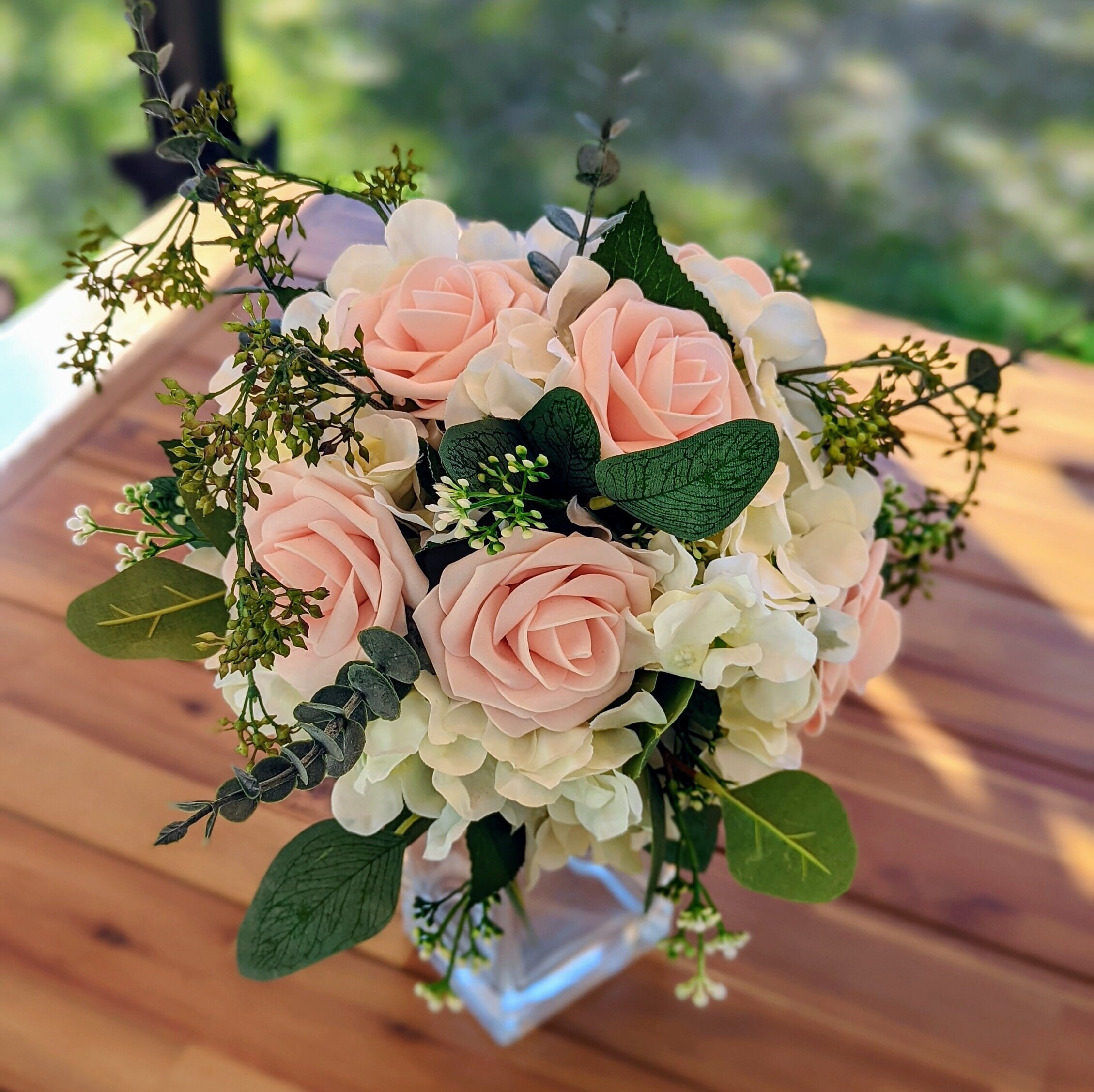 Wedding bouquet of white hydrangea and pink roses with diamond pins.  Doristhefloristt.com