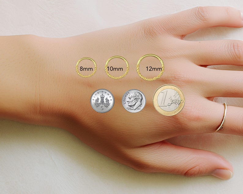 May include: Three gold hoop rings with a twisted texture, labeled with diameters of 8mm, 10mm, and 12mm. The hoops are displayed alongside a five pence coin, a US dime, and a one euro coin for scale, with one hoop worn on a finger.