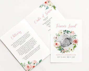 May include: A white card with a pink floral border and a black and white photograph of a baby girl. The text "Forever Loved" is written in pink cursive. The baby's name, Ashley Anderson, and the dates July 14, 2022 - May 27, 2023 are printed below the photograph.