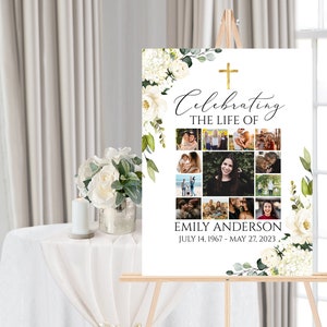 K&ouml;nnte beinhalten: Ein wei&szlig;es Gedenkschild mit einem goldenen Kreuz und einem floralen Rand. Das Schild tr&auml;gt die Aufschrift "Celebrating the Life of Emily Anderson July 14, 1967 - May 27, 2023". Das Schild ist mit einer Fotocollage verziert.