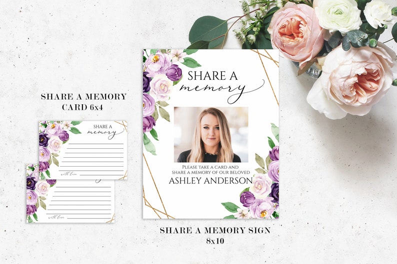 May include: A white 8x10 inch sign with a gold geometric frame and purple and white floral design. The sign says "Share a memory" and includes a photo of a woman. The sign also includes the text "Please take a card and share a memory of our beloved Ashley Anderson".