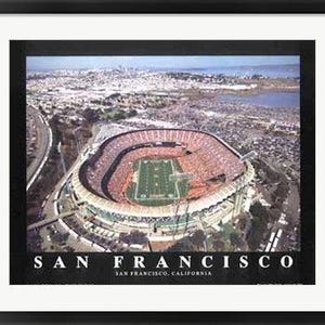 May include: Framed aerial view of a stadium in San Francisco, California. The stadium is filled with people, and a football field is visible in the center. The image is framed in black, with the words "SAN FRANCISCO" at the bottom.