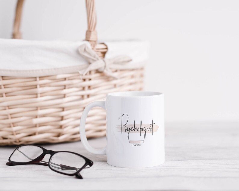 May include: White ceramic mug with a black and brown graphic that says "Psychologist Loading".