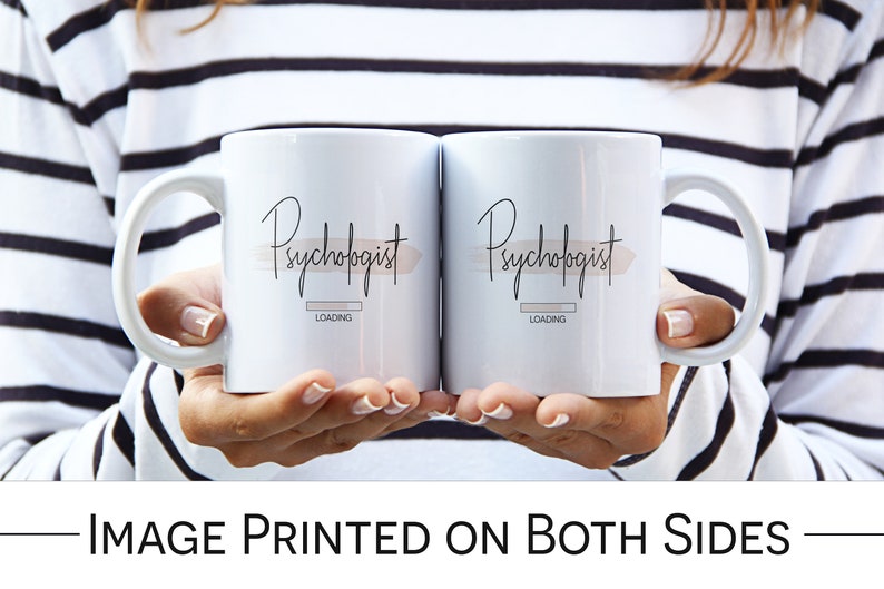 May include: Two white coffee mugs with black text that reads "Psychologist Loading" on each mug. The mugs are held by a person wearing a black and white striped sweater.