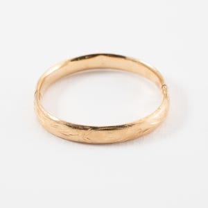 Antique Baby Bangle 14k Yellow Gold Bracelet with visible dents and pattern design