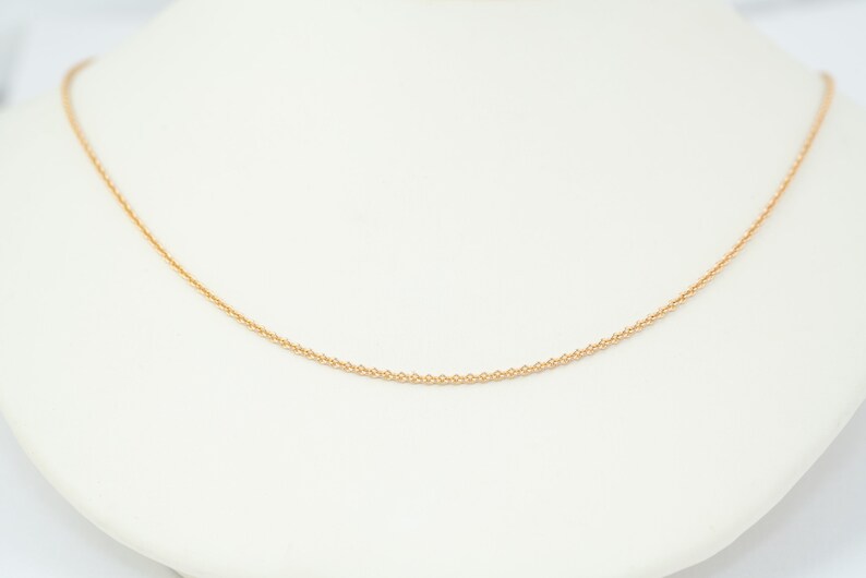 May include: A delicate gold chain necklace, perfect for layering or wearing alone.