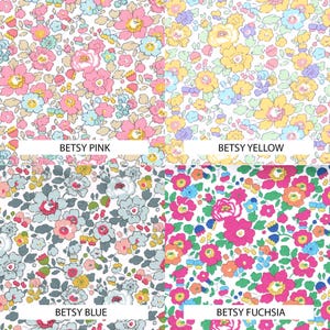 May include: A four-quadrant collage of floral fabric patterns. Top left is Betsy Pink with pink and blue flowers. Top right is Betsy Yellow with yellow and blue flowers. Bottom left is Betsy Blue with grey and blue flowers. Bottom right is Betsy Fuchsia with fuchsia and orange flowers.