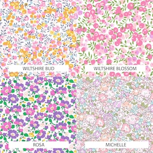May include: A four-quadrant fabric pattern display. Top left: Wiltshire Bud with yellow and pink berries on gray stems. Top right: Wiltshire Blossom with pink berries and green leaves. Bottom left: Rosa with purple and pink flowers. Bottom right: Michelle with light pink and blue floral clusters.