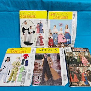 May include: A collection of costume sewing patterns from McCall's, Simplicity, and other brands. The patterns feature various historical and fantasy costume designs, including medieval, retro, and character outfits. The patterns are packaged in colorful envelopes.