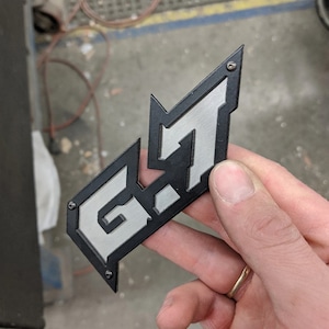 6.7 Emblem - Black on Brushed Stainless - Pair