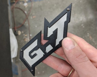 Emblema 6.7 - Negro sobre acero inoxidable cepillado - Par