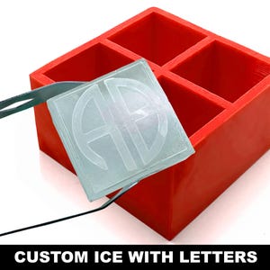 May include: A red silicone ice cube tray with four square molds. A clear ice cube with a monogram design is being removed with tongs. The text "CUSTOM ICE WITH LETTERS" is displayed at the bottom of the image.