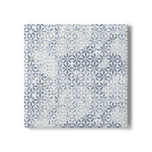 May include: A white and blue patterned fabric with a distressed look. The pattern is made up of small, repeating flower shapes.