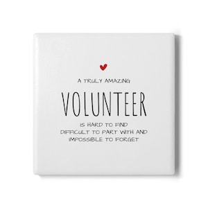 May include: A white square with the text "A TRULY AMAZING VOLUNTEER IS HARD TO FIND DIFFICULT TO PART WITH AND IMPOSSIBLE TO FORGET" in black font. A small red heart is above the word "VOLUNTEER".