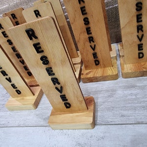 RESERVE. RESERVED. wooden table sign. a sign of a reserved table