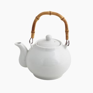 May include: A white ceramic teapot with a bamboo handle and a lid. The teapot has a round body and a spout.