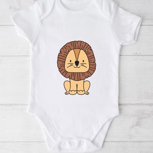 May include: White baby onesie with a cartoon lion wearing a brown mane. The lion is sitting down with its paws in front of it.