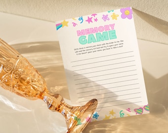 May include: A printable memory game card with a pink, green, and blue color scheme. The card has a title that says "Memory Game" and instructions for playing the game. The card is decorated with stars, flowers, and other fun designs.