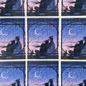 May include: A set of nine illustrated cards featuring a couple embracing under a crescent moon and starry sky. The couple is silhouetted against a dark blue background with a red ribbon flowing behind them. The cards are framed by a black lattice design.